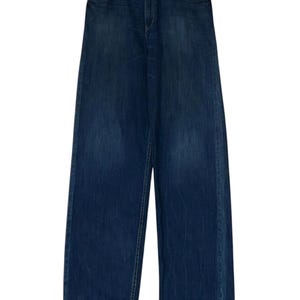 May include: A pair of dark blue denim jeans hanging on a wooden hanger. The jeans have a straight leg and a relaxed fit.