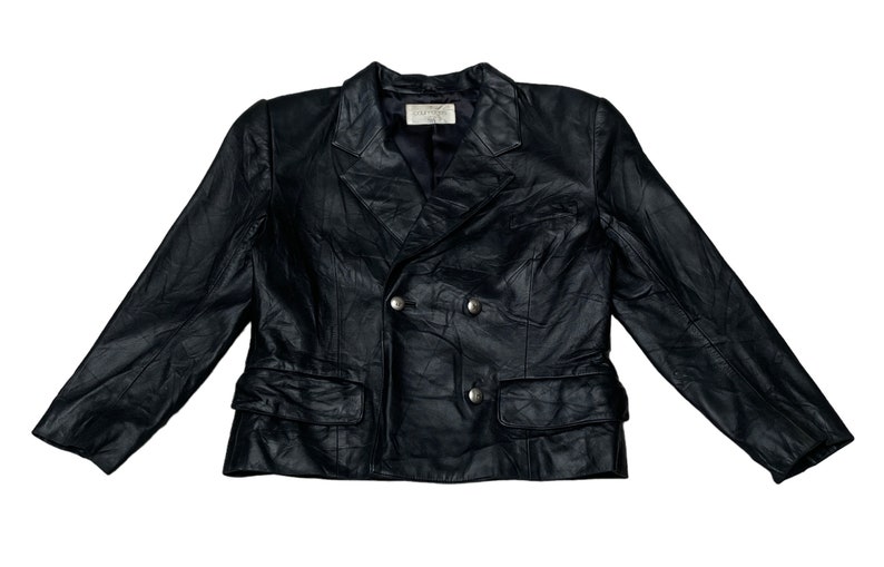 May include: A black leather blazer with a double-breasted closure and two front pockets. The blazer has a textured look and features silver buttons.