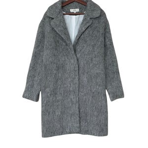 May include: A gray long-sleeved coat with a collar and a button closure.