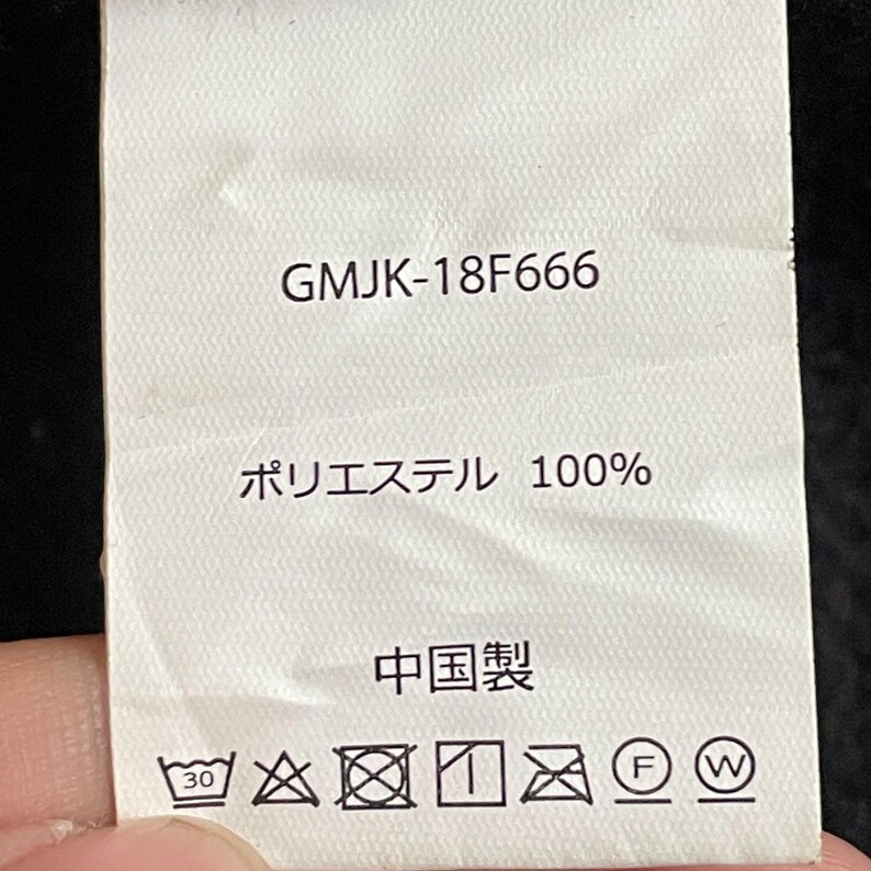 May include: White tag with black text. The tag says "GMJK-18F666", "Polyester 100%", "Made in China", and has care instructions.