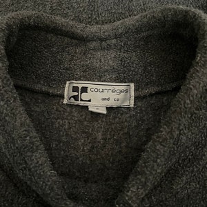 May include: A gray fleece jacket with a black button closure and a label that reads "Courr&egrave;ges and Co."