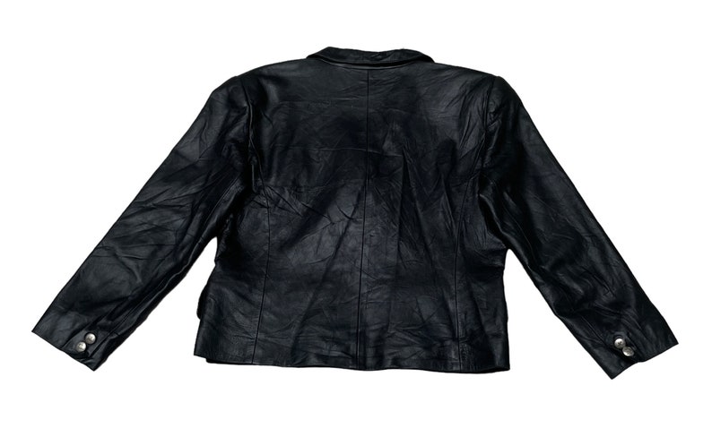 May include: A black leather jacket with a button closure and long sleeves.