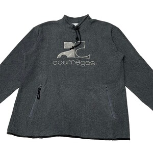 May include: A gray long-sleeve sweatshirt with a zippered pocket on each side. The sweatshirt has a white embroidered logo that says "Courr&egrave;ges" and a stylized "2C" design.