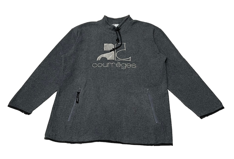 May include: A gray long-sleeve sweatshirt with a zippered pocket on each side. The sweatshirt has a white embroidered logo that says "Courr&egrave;ges" and a stylized "2C" design.