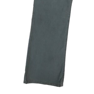 May include: A pair of dark grey trousers with a straight leg fit.