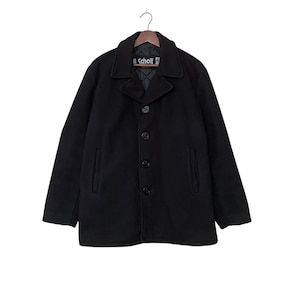 May include: A black peacoat with a button closure and a Scholt label. The coat has two pockets on the front and a lined interior.