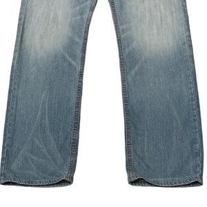 May include: A pair of light blue denim jeans with a straight leg fit. The jeans have a classic five-pocket design and are made from a soft, comfortable cotton blend.