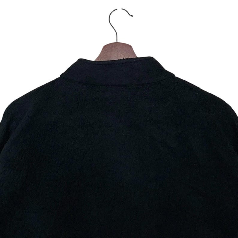 May include: Black fleece jacket with a zipper closure and a stand-up collar.
