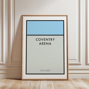 May include: A framed rectangular wall art print featuring a light blue horizontal bar at the top over a larger light gray section. The text COVENTRY ARENA is printed in black sans-serif font in the center, with CV6 6GE printed at the bottom.