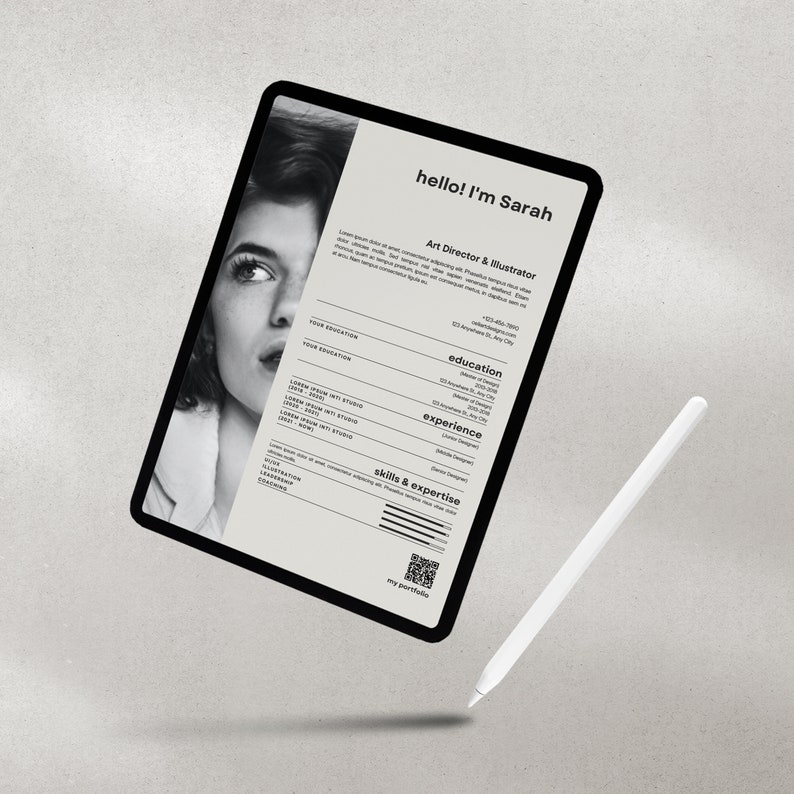 May include: A black tablet displays a resume with the text "hello! I'm Sarah, Art Director & Illustrator." The resume includes sections for education, experience, and skills. A white stylus is positioned near the tablet.
