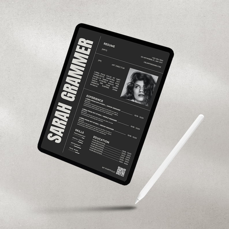 May include: A black and white resume on a tablet screen with the name Sarah Grammer at the top. The resume lists her experience as a Junior Designer, Middle Designer, and Senior Designer. It also lists her skills and education. The tablet is on a gray surface with a white stylus next to it.