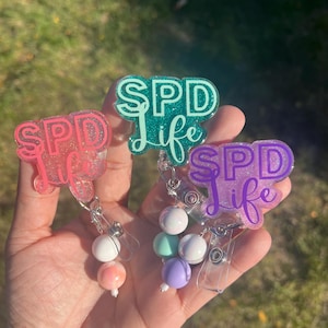 Carrete de insignia SPD Life: tecnología de procesamiento estéril con brillantina y cuentas extraíbles