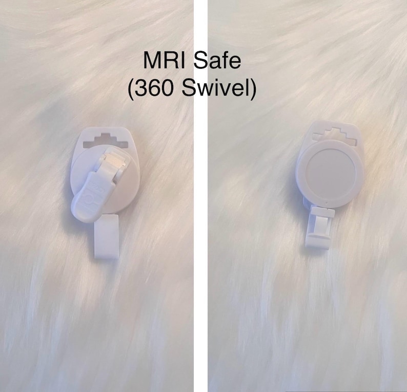 May include: Two white, MRI-safe badge reels with a 360-degree swivel feature. The reels have a round, flat surface with a clip on the back and a small strap for attaching a badge. The text "MRI Safe (360 Swivel)" is visible.