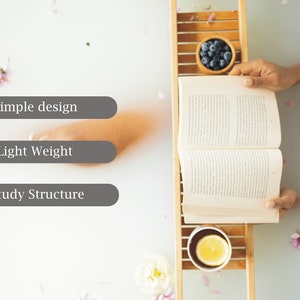 May include: A wooden bath tray holds a bowl of blueberries, a cup with a lemon slice, and an open book. The scene is set in a tub filled with water and flower petals. The text on the image says: Simple design, Light Weight, Study Structure.