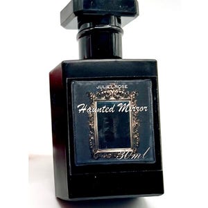 May include: A black rectangular perfume bottle with a matching cap. The label reads "Juliet Rose Haunted Mirror" with a decorative frame. The bottle contains 30ml of perfume.