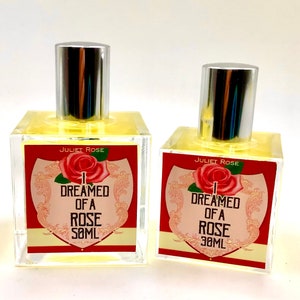 Puede incluir: Dos botellas de vidrio transparente con tapas plateadas y l&iacute;quido amarillo en su interior. Las etiquetas son rojas con texto blanco que dice "Juliet Rose I Dreamed of a Rose 30ML".
