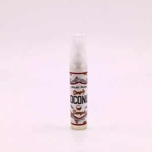 May include: A small clear bottle with a white label that says "Juliet Rose Simply Coconut Sample".