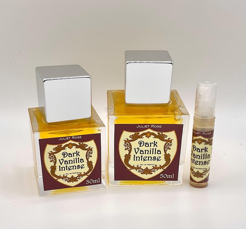 May include: Three perfume bottles with silver caps. Two square bottles are labelled "Dark Vanilla Intense" with 30ml and 50ml sizes. A smaller spray bottle is also labelled "Dark Vanilla Intense". The bottles contain a yellow liquid.