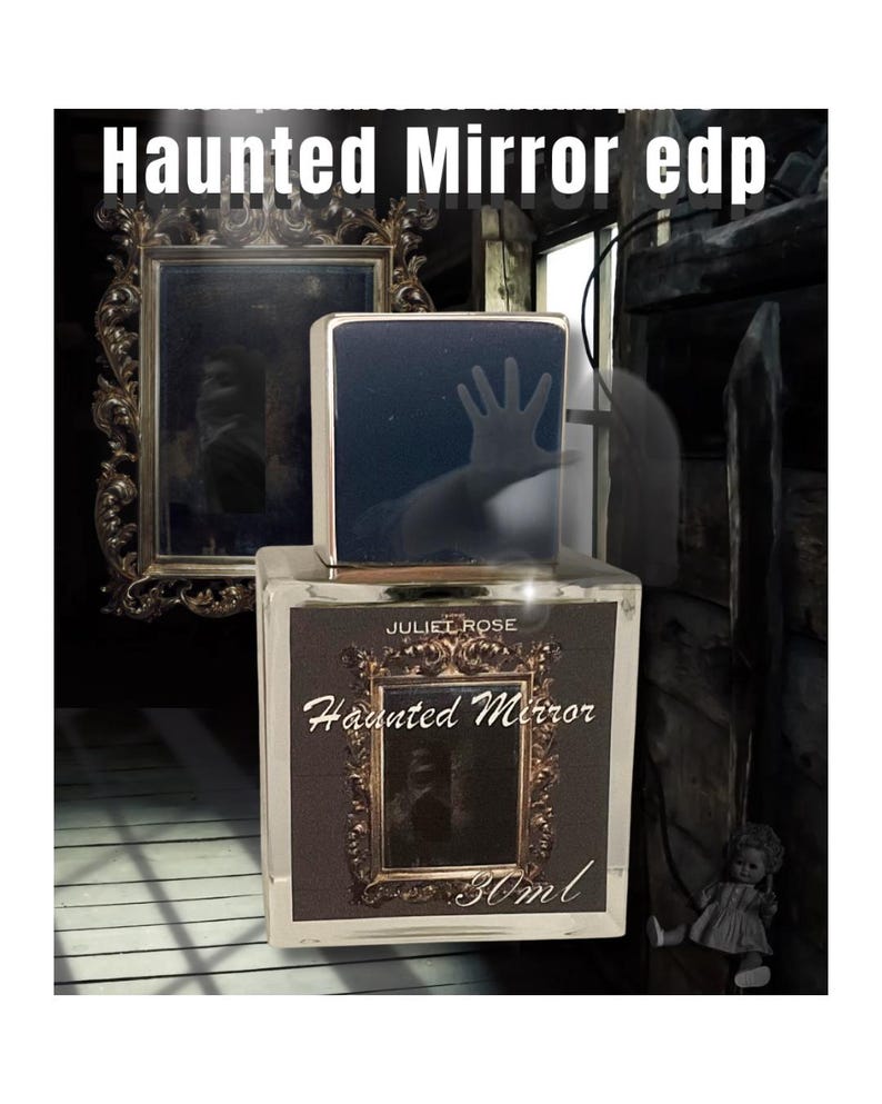 May include: A perfume bottle with the text "Haunted Mirror edp" and "Juliet Rose" on the label. The bottle has a dark, rectangular design with a hand silhouette on the top. The label features a framed mirror design. The bottle contains 30ml.