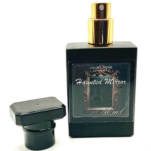 May include: A black rectangular perfume bottle with a gold-colored sprayer and a separate black cap. The label reads "JULIET ROSE Haunted Mirror 30ml". The bottle is on a white background.