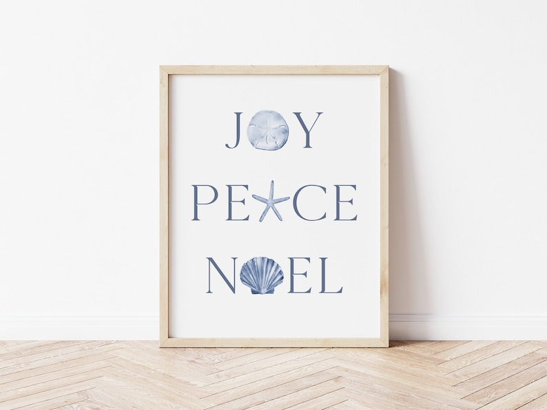 Puede incluir: Una impresi&oacute;n enmarcada con las palabras "JOY PEACE NOEL" en texto azul. Cada palabra est&aacute; decorada con una concha diferente.