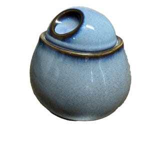 May include: A blue ceramic sugar bowl with a lid. The lid has a small opening for pouring sugar.