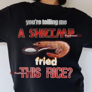 May include: A black t-shirt with a red graphic that says "You're telling me a shrimp fried this rice?" with a cartoon shrimp holding a spoon with rice in it.
