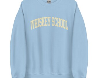 May include: Light blue sweatshirt with the text "WHISKEY SCHOOL" in a yellow-cream color.