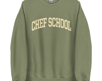 May include: A green sweatshirt with the text "CHEF SCHOOL" in a white arch across the front.