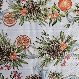 May include: A white background with a repeating pattern of pine cones, sprigs of greenery, red berries, and orange slices. The pattern is reminiscent of a holiday wreath.