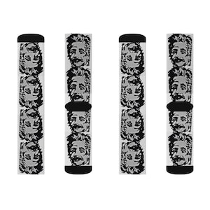 May include: Four pairs of white socks with a black and white repeated pattern of a man's face. The socks are crew length and have a black cuff.