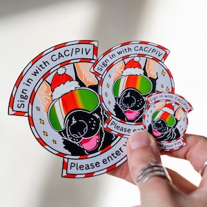 May include: Three Christmas-themed stickers featuring a cartoon dog wearing a Santa hat and sunglasses. The stickers say "Sign in with CAC/PIV" and "Please enter your PIN".