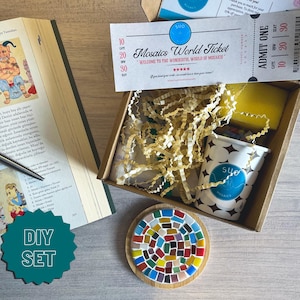 May include: A DIY mosaic kit with a colourful mosaic tile coaster, a small container of mosaic tiles, a sponge, and a ticket that says "Mosaics World Ticket".