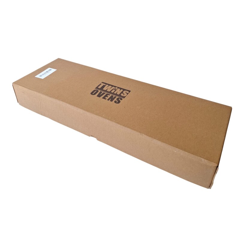 May include: A rectangular cardboard box with the text "TWINS OVENS" printed in black. The box is a light brown color and has a small white label on the top left corner.