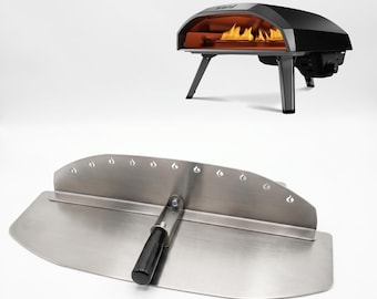 May include: A black outdoor pizza oven with a stainless steel pizza peel. The oven has a black exterior, a silver top, and a fire visible inside. The pizza peel is silver with a black handle.