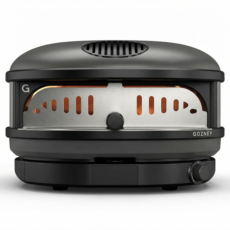 May include: A black outdoor pizza oven with a stainless steel interior. The oven has a rounded top with a vent and a control knob on the side. The brand name "GOZNEY" is visible on the front.