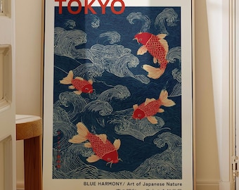May include: A framed art print featuring red koi fish swimming in a blue ocean with white wave patterns. The word "TOKYO" is printed in red at the top. The text "BLUE HARMONY/ Art of Japanese Nature" is at the bottom.