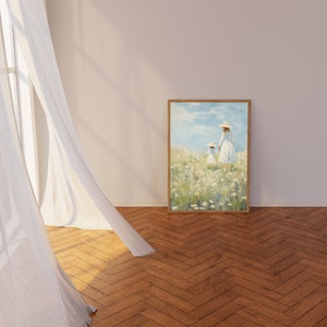Peut inclure: Une peinture encadr&eacute;e repr&eacute;sentant deux personnages en robes blanches marchant dans un champ de fleurs blanches. Le ciel est bleu avec des nuages blancs. La peinture est dans un cadre en bois.