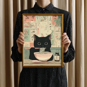 Cute cat wall art for living room — charming illustration of a black cat enjoying ramen, perfect for a cozy atmosphere.