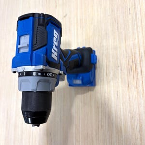 May include: A blue and black Kreg cordless drill. The drill has a black chuck, a gray adjustment collar, and a blue body with the Kreg logo. The drill is designed for woodworking and home improvement projects.