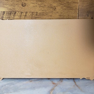 May include: A plain, light brown rectangular board with a slightly textured surface.