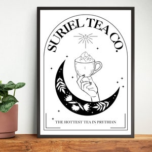 May include: Black and white illustration of a hand holding a cup of tea with a mountain design. The text "SURIEL TEA CO." is written in a circle around the hand and cup. The text "THE HOTTEST TEA IN PRYTHIAN" is written below the hand and cup.