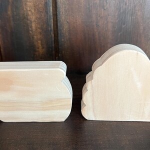 May include: Two unfinished wooden shapes, one shaped like a pot and the other shaped like a beehive.