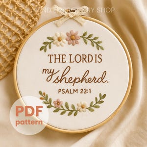 May include: An embroidery hoop with the text "THE LORD IS my shepherd. PSALM 23:1". The design includes embroidered flowers in pink, white, and green, with a beige background. A PDF pattern is also available.