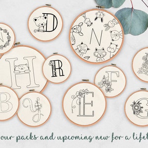 May include: A set of 10 embroidery hoop designs featuring various letters of the alphabet, including floral, animal, and geometric patterns. The designs are black and white and are perfect for embroidery projects.