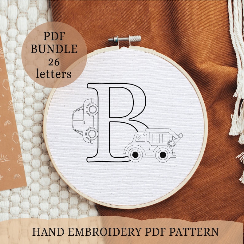 May include: A white embroidery hoop with a black outline of the letter B. A car and a dump truck are incorporated into the letter design. The text "PDF BUNDLE 26 letters" is in a white box with a black outline.