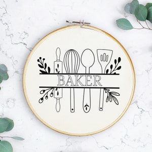 May include: A white embroidery hoop with a black outline of a rolling pin, whisk, spoon, and spatula. The word "BAKER" is written in black letters above the tools.