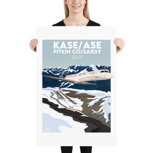 May include: A vintage travel poster featuring a white airplane flying over a snowy mountain range. The poster has the text "KASE/ASE PITKIN CO/SARDY Apt Elev 7820' TDZE 7737'" in a blue and white font.