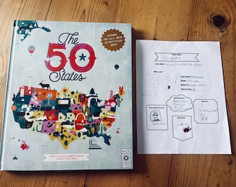 May include: A colorful illustrated book titled "The 50 States" with a map of the United States on the cover.  The book is open to a page with a blank worksheet titled "State Name: Oklahoma". The worksheet has sections for state facts, interesting facts, famous people, state flower, and state bird.