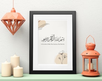 May include: A black framed print featuring Arabic calligraphy with the text "بسم الله الرحمن الرحيم" meaning "In the name of Allah, Most Gracious, Most Merciful". The print is on a white background with a brown and beige abstract design.